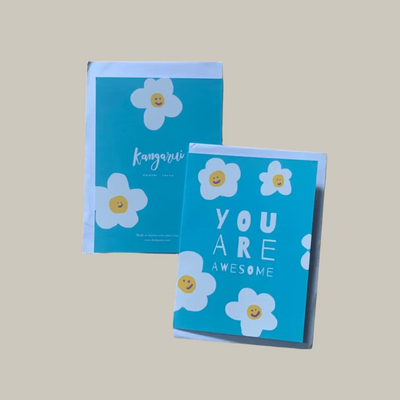 Two blue cards with white flowers and text on a beige background