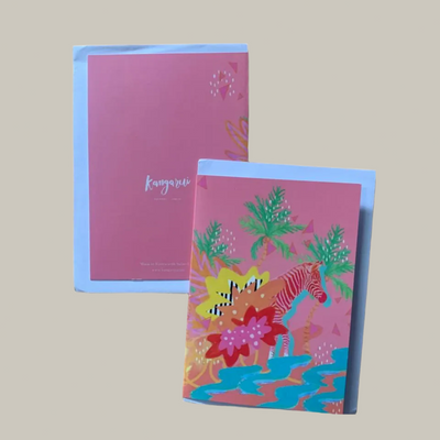 Two notebooks with colorful zebraillustrations on a beige background