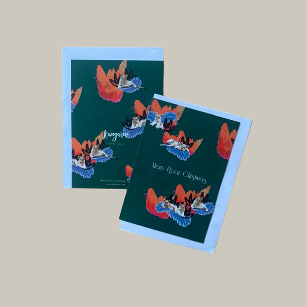 Two greeting cards with colorful designs and lion cubs on a beige background