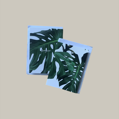 Two notebooks with leaf patterns on a beige background