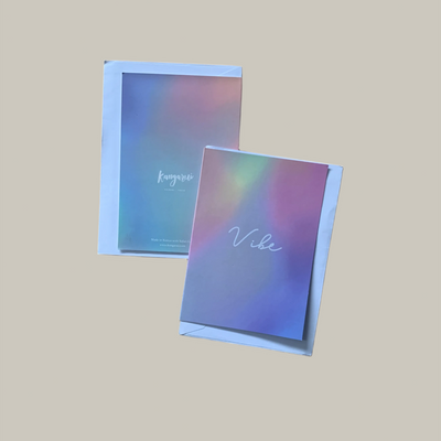 Two colorful notebooks with 'Vibe' branding on a beige background